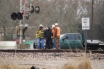 Track supervisor, track inspector and a couple of the VFD prying a crossing panel to clear the flangeway
